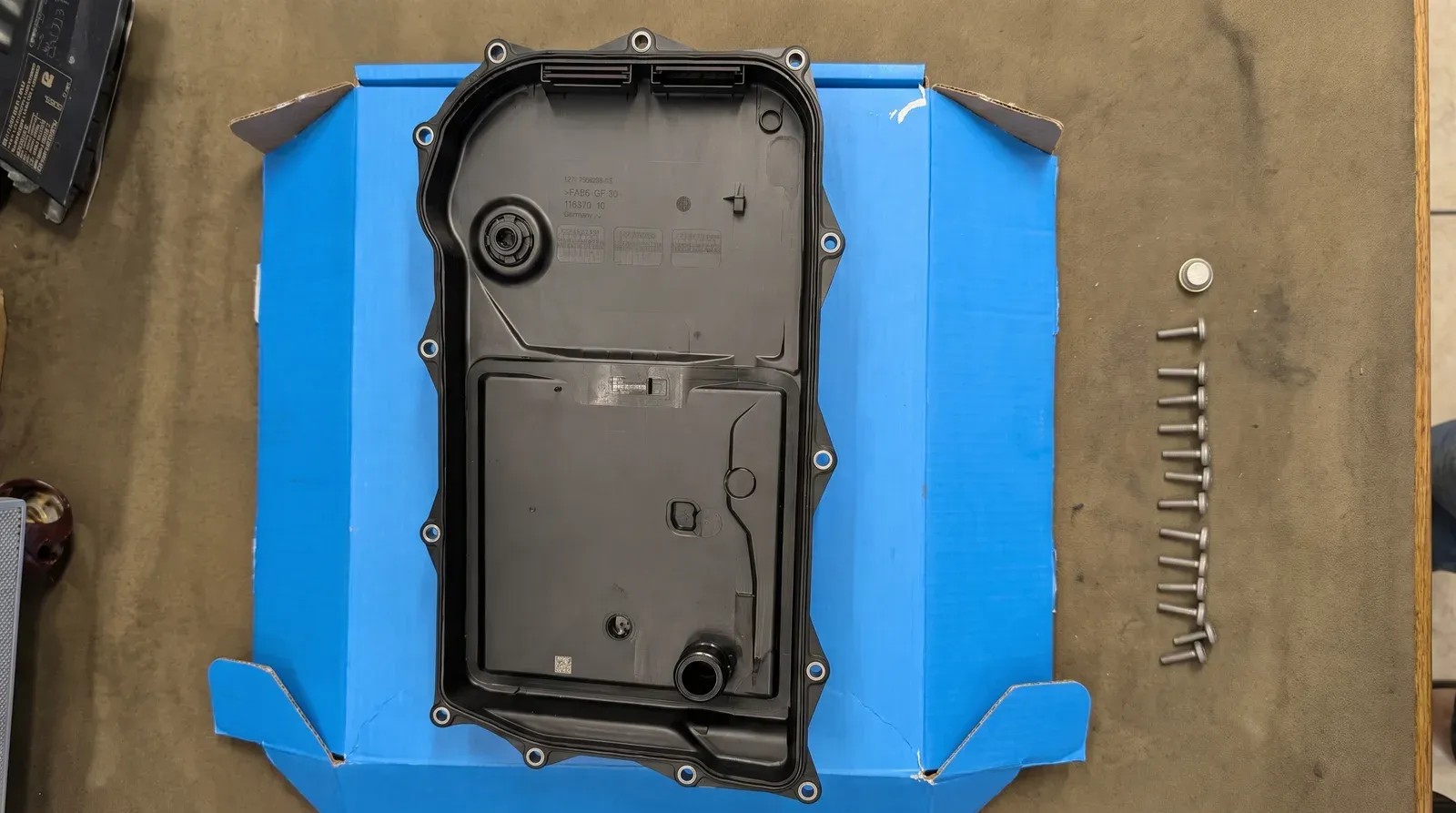 New ZF automatic gearbox filter sump and fasteners, ready to fit during an oil change at the workshop